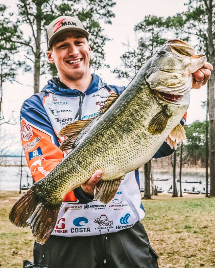 Professional angler Grae Buck holding up a giant largemouth bass.